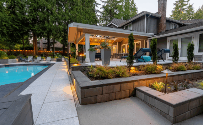 a pool and patio with chairs and trees