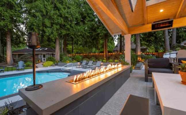 a fire in a fireplace next to a pool